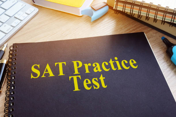 SAT Practice Tests with textbooks on a desk. SAT Practice Tests with textbooks on a desk.